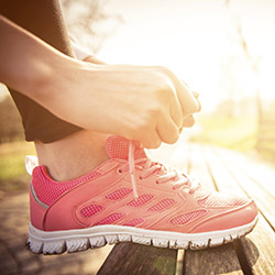 a runner stopped to tie her lace
